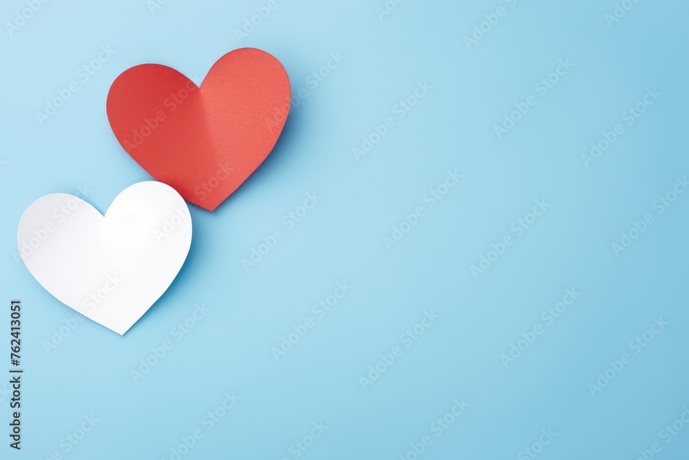 White and red paper hearts on a soothing pastel blue backdrop. Paper Hearts on Pastel Blue Background