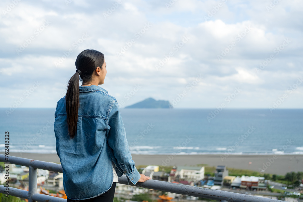 Tourist woman look at the Guishan island In Yilan of Taiwan