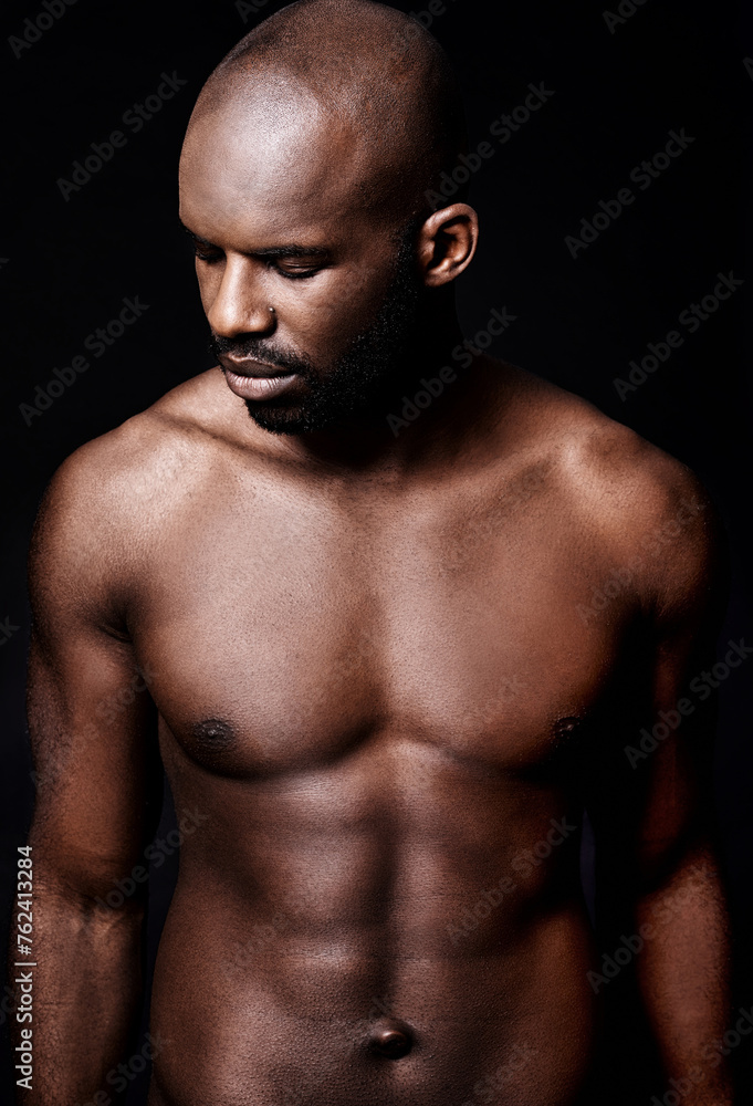 Fototapeta premium Black man, shirtless and body with six pack, fitness and health with muscle isolated on dark background. Exercise, sport and athlete with abs, confident and masculine with testosterone in studio