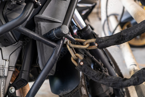 .Large chains and padlocks are used to protect motorcycles from thieves.