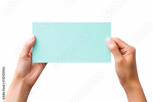 A hand holding a cyan paper isolated on white background