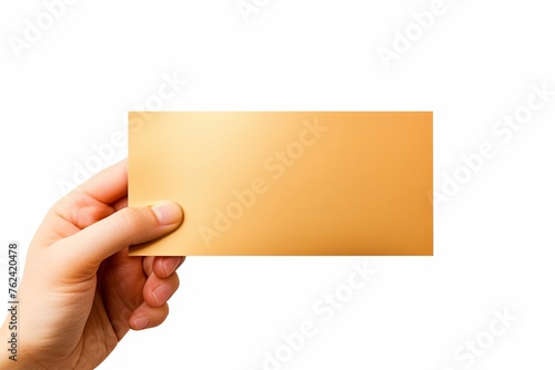 A hand holding a gold paper isolated on white background