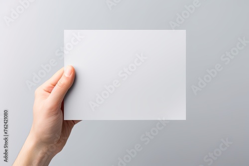 A hand holding a gray paper isolated on white background, elements