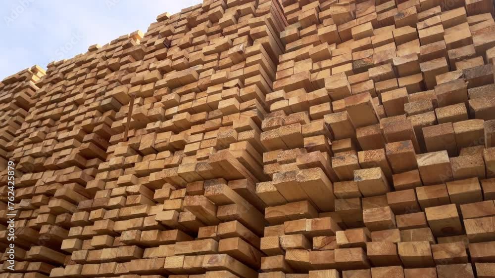 Stacked Timber Planks at a Lumberyard Awaiting Transportation. Stacked wooden planks in varying shades of brown at a timber storage facility. Stacked Timber Planks at a Lumberyard Awaiting Transportation. Stacked wooden planks in varying shades of brown at a timber storage facility.
