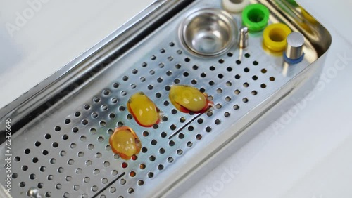 PRF membrane preparation. Fibrin clots on a perforated metal tray. PRF is placed in prf box. Fibrin clots of a gel-like consistency using for preparation of membranes. Modern dental surgery. Close-up.