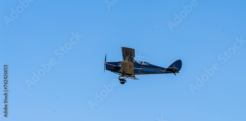 A De Havilland bi-winged Fox Moth flying at an airshow