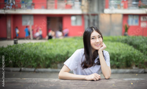 sharming teenage asian girl smiling on university student uniform