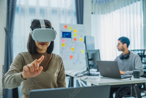 Asian and Indian developer program coding sent to virtual reality headset to implement ai project at office