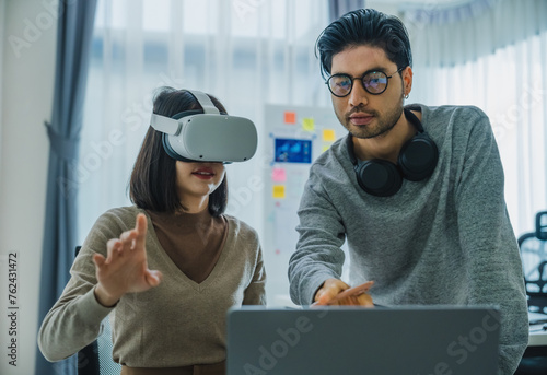 Asian and Indian developer program coding sent to virtual reality headset to implement ai project at office