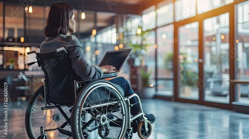 Disabled person in a wheelchair working with a laptop