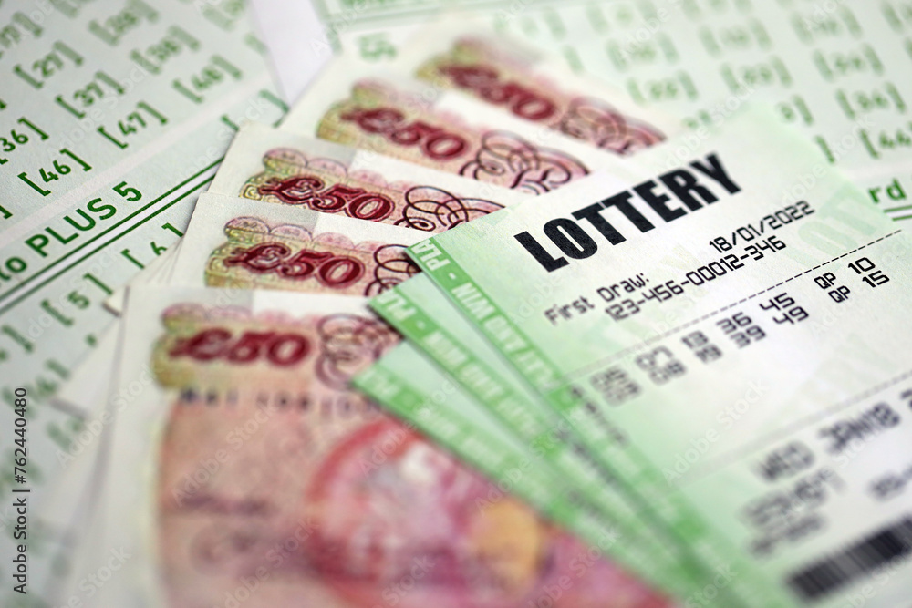 Green lottery tickets and Great Britain pounds money bills on blank with numbers for playing lottery close up Green lottery tickets and Great Britain pounds money bills on blank with numbers for playing lottery close up