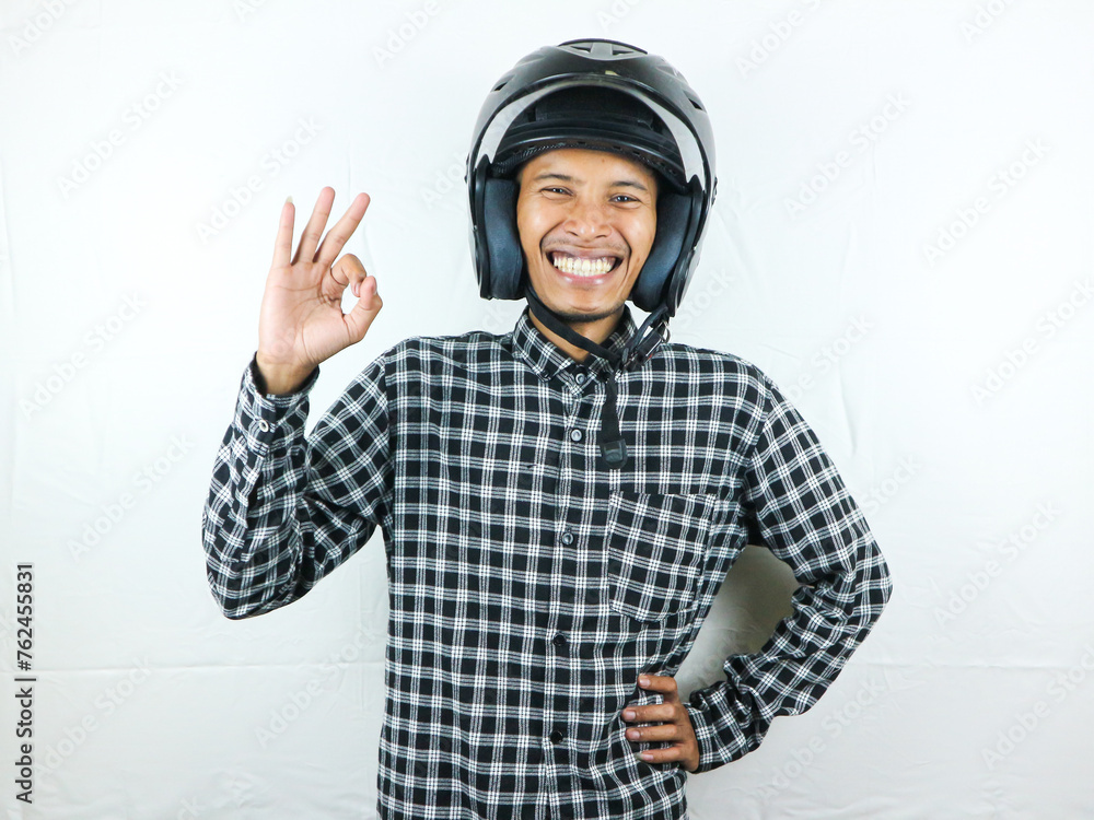 Portrait Asian man holding motorcycle helmet with excited expression. Safety riding. Portrait Asian man holding motorcycle helmet with excited expression. Safety riding.