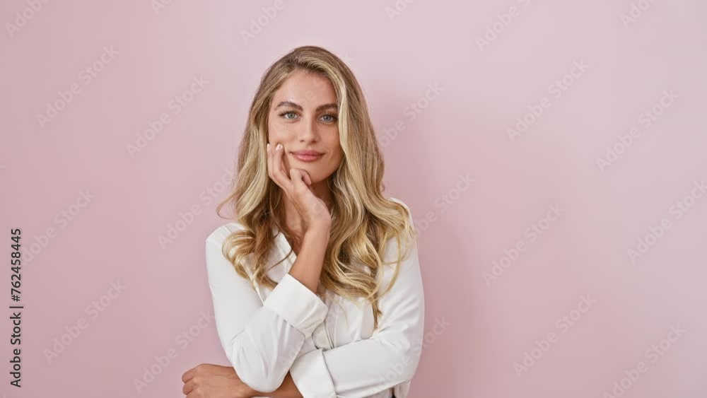 Proud and positive, beautiful blonde woman stands tall, smiling at camera wearing shirt. confidently posing with crossed arms, hand on chin, over pink isolated background. Proud and positive, beautiful blonde woman stands tall, smiling at camera wearing shirt. confidently posing with crossed arms, hand on chin, over pink isolated background.