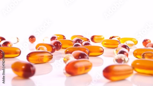 Various white, orange and transparent Capsules isolated on white Background - Healthy Nutrition Pills photo