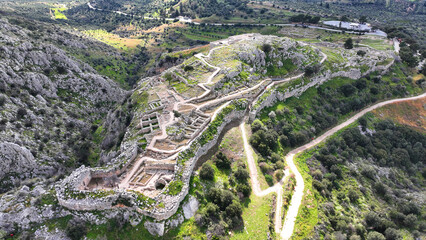 Aerial drone scenic photo of uphill iconic archaeological site of Ancient citadel of Mycenae famous for round tomb of Agamemnon and Lion Gate, Argolida, Peloponnese, Greece