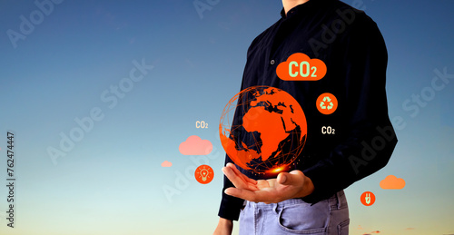 Carbon Neutrality and Net Zero concept. green net center icon in hand, sunset background