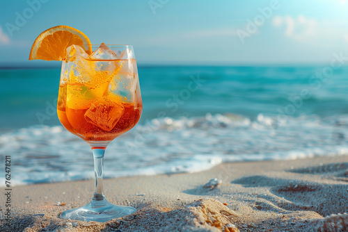Aperol Spritz cocktail on a sandy beach with a sea view and space for text