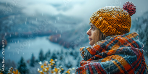 A person stands amidst falling snow, wrapped in a cozy plaid scarf and sporting a vibrant knit cap photo