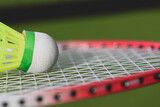 Closeup background with badminton shuttlecock on a racket.