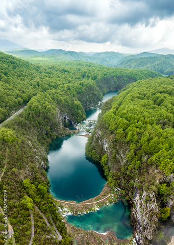 Amazing aerial view of Plitvice national park with lakes and picturesque waterfalls in a green spring forest, Croatia.