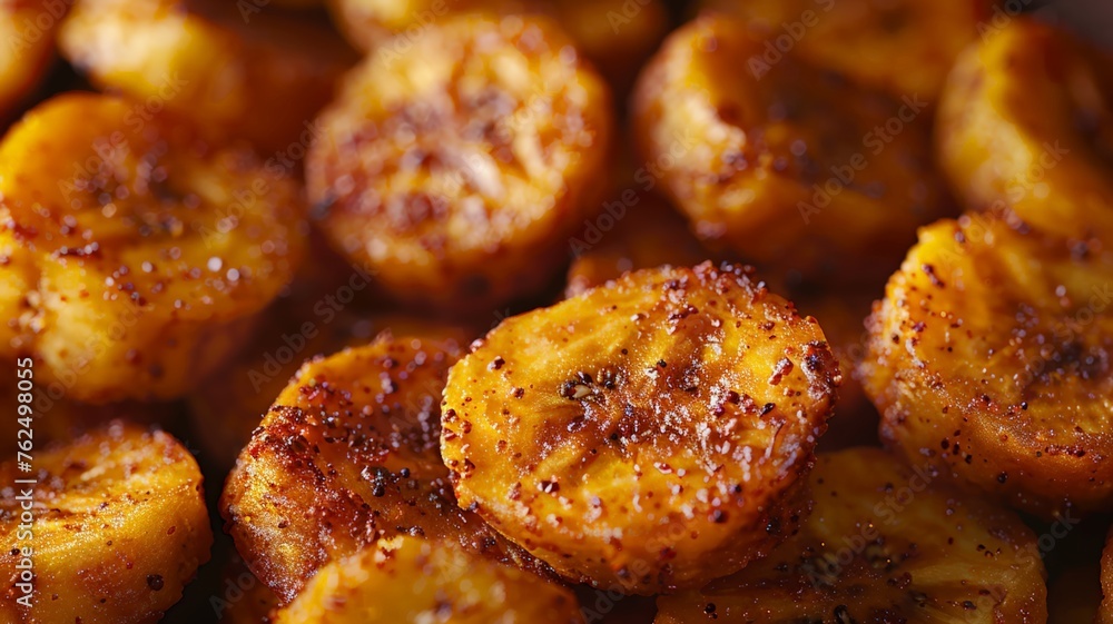 Close-up of caramelized golden fried plantains sprinkled with sugar Close-up of caramelized golden fried plantains sprinkled with sugar