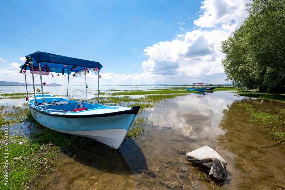 Obraz premium Decorated day-trip boats in Isikli Lake in Denizli's Civril district. Isıkli Lake is flooded with visitors during lotus time. It is also a popular lake for hunters.