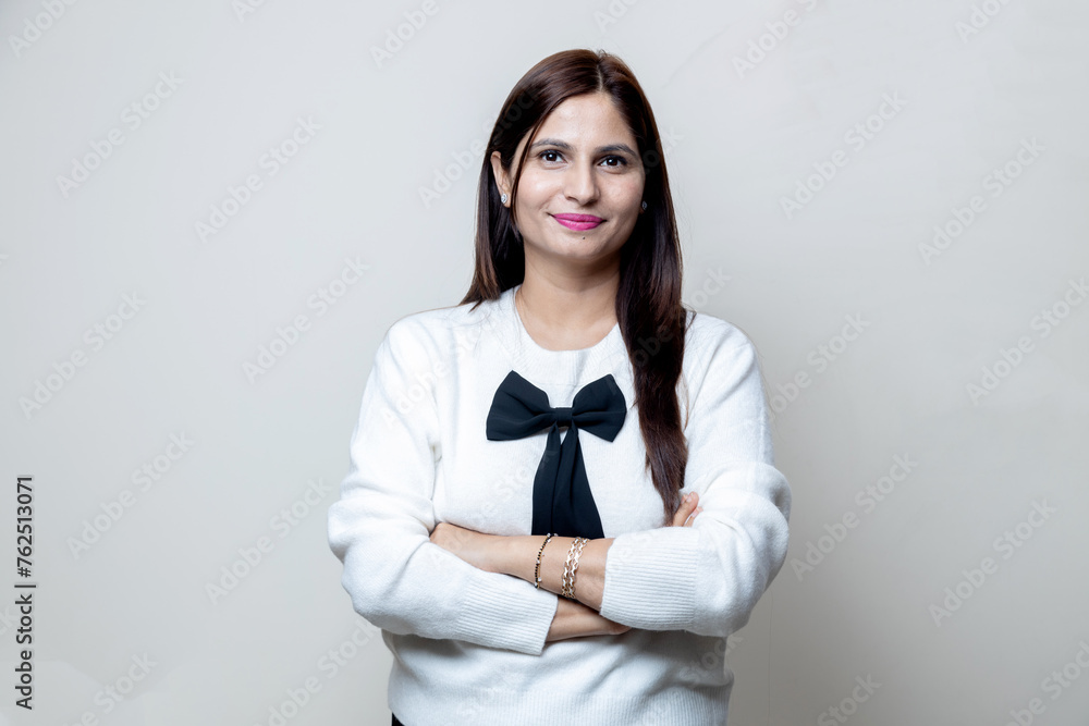 portrait of happy latin indian female with cross arm looking towards the camera portrait of happy latin indian female with cross arm looking towards the camera