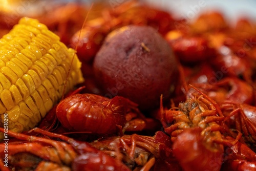 Boiled Corn on the Cob and Boiled Red Potato on a bed of Boiled Crawfish 