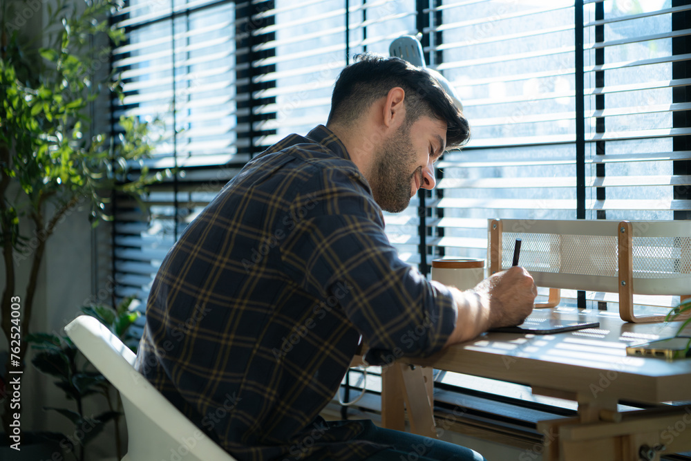 Handsome young man working on computer at home, Work from home concept. Handsome young man working on computer at home, Work from home concept.