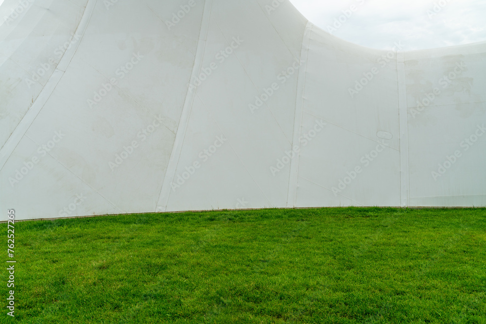 white wall with empy green meadow. white wall with empy green meadow.