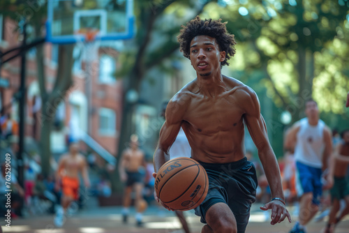 A young man plays basketball on a street court