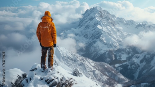 Man Standing on Snow Covered Mountain Top