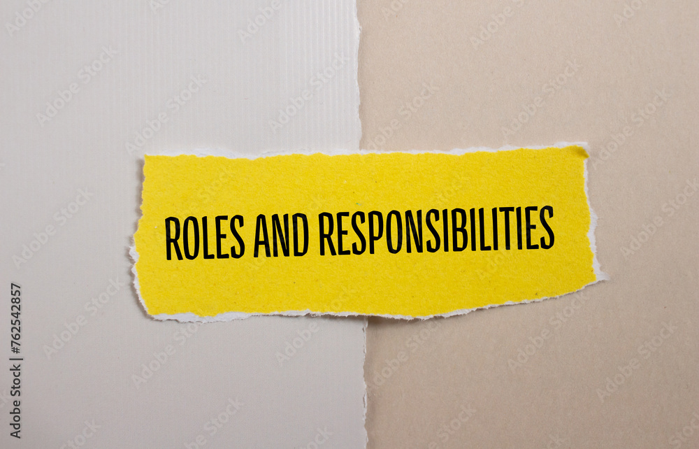 Roles and responsibilities words written on yellow torn paper ...