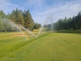 Sprinkler Spraying Water on Golf Course