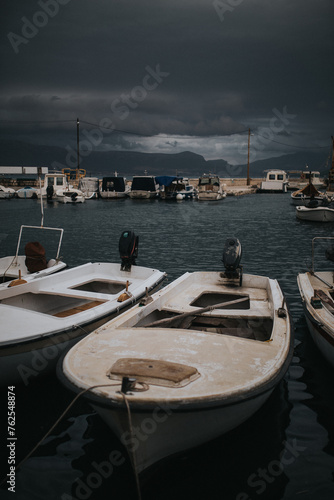 old fishing boats at harbor at sea in a dark and cloudy day