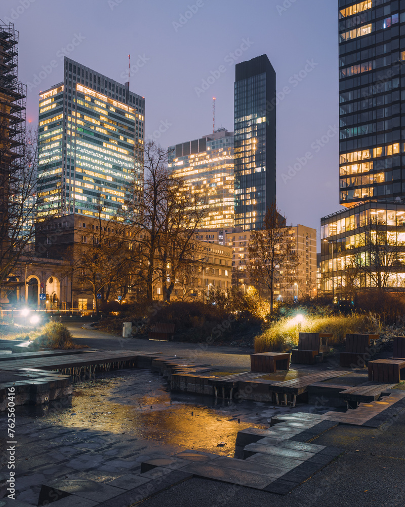 Naklejka premium Warsaw, Poland - a view of a skyscrapers in the business part of the city. Office buildings in the Center of Warsaw. Long exposure. City at night
