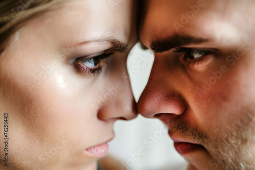 An intense close-up of a man and woman, foreheads touching, sharing a moment of deep connection.