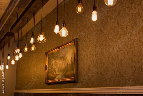 interior of the old house, Edison light bulbs, old painting on wall, gold tones 