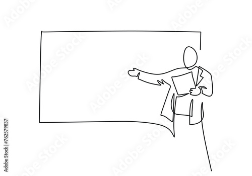 teacher giving a lesson in from of the class behind the blackboard