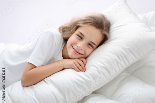 Young girl is smiling and laying on white pillow. Pillow is soft and fluffy, providing comfortable surface for her to rest on. Concept of relaxation and happiness