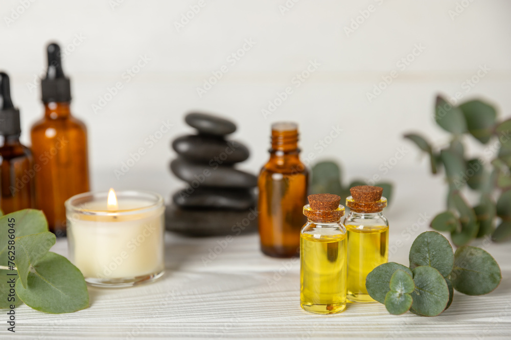 Eucalyptus essential oil in a glass bottle with green eucalyptus leaves on a textured wooden background. Aromatherapy concept. Spa. Natural organic ingredients for cosmetics and body care.Copy space Eucalyptus essential oil in a glass bottle with green eucalyptus leaves on a textured wooden background. Aromatherapy concept. Spa. Natural organic ingredients for cosmetics and body care.Copy space