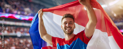Happy Czech male supporter with Czech republic flag, Czech male fan at a sports event such as football or rugby match, blurry stadium background, copy space