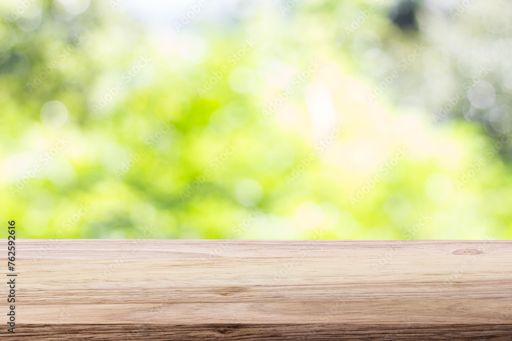 Wood table top on bokeh green bright background. For montage product display or design key visual layout Wood table top on bokeh green bright background. For montage product display or design key visual layout
