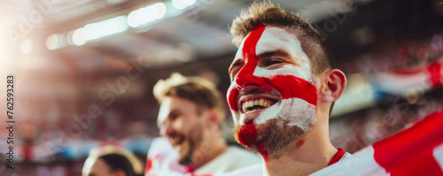 Happy English male supporter with face painted in English flag consists of a white field (background) with a red cross, English male fan at a sports event such as football or rugby match photo