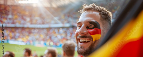 Happy German male supporter with face painted in German flag german flag consists of A horizontal tricolour of black, red, and gold, German male fan at a sports event such as football  © Pixelmagic