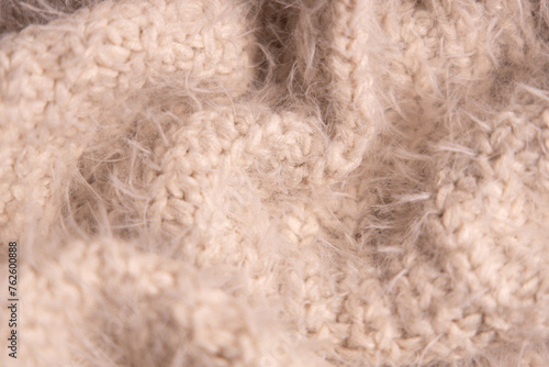 White knitwear texture. Soft texture of homemade cashmere wool sweater. photo