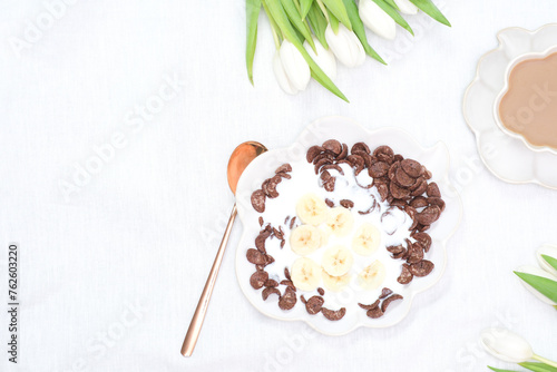 Wallpaper Mural The concept of a healthy breakfast of vegetarian yogurt, cornflock and fresh fruit, coffee, flowers white tulips on white background. Top view. Torontodigital.ca