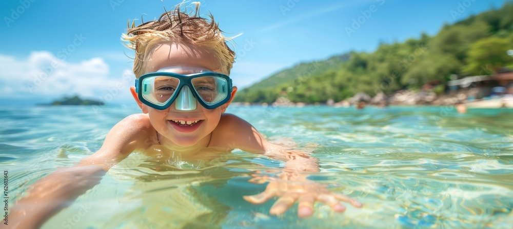 Fototapeta premium Adventurous kid snorkeling alone in crystal clear waters of remote tropical island
