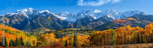 A painting showcasing a majestic mountain range in vibrant autumn colors. The leaves are changing to hues of red, orange, and yellow, creating a stunning contrast against the rocky peaks. The scene ca © vadosloginov