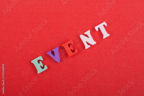 EVENT word on red background composed from colorful abc alphabet block wooden letters, copy space for ad text. Learning english concept.